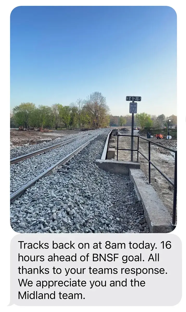 A text message that reads, "Tracks back on at 8am today. 16 hours ahead of BNSF goal. All thanks to your teams response. We appreciate you and the Midland team."